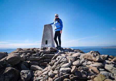 julie milne superfine managing director stands on a mountain peak