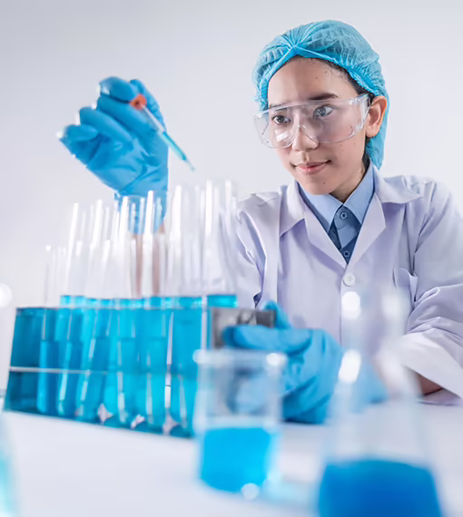 Superfine chemist filling test tubes with blue liquid